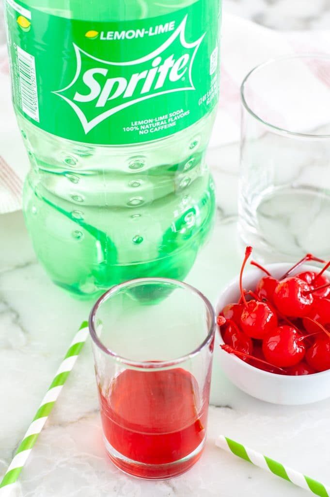 Bottle of Sprite, maraschino juice and cherries. 