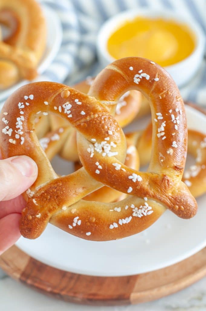 Hand holding a pretzel.