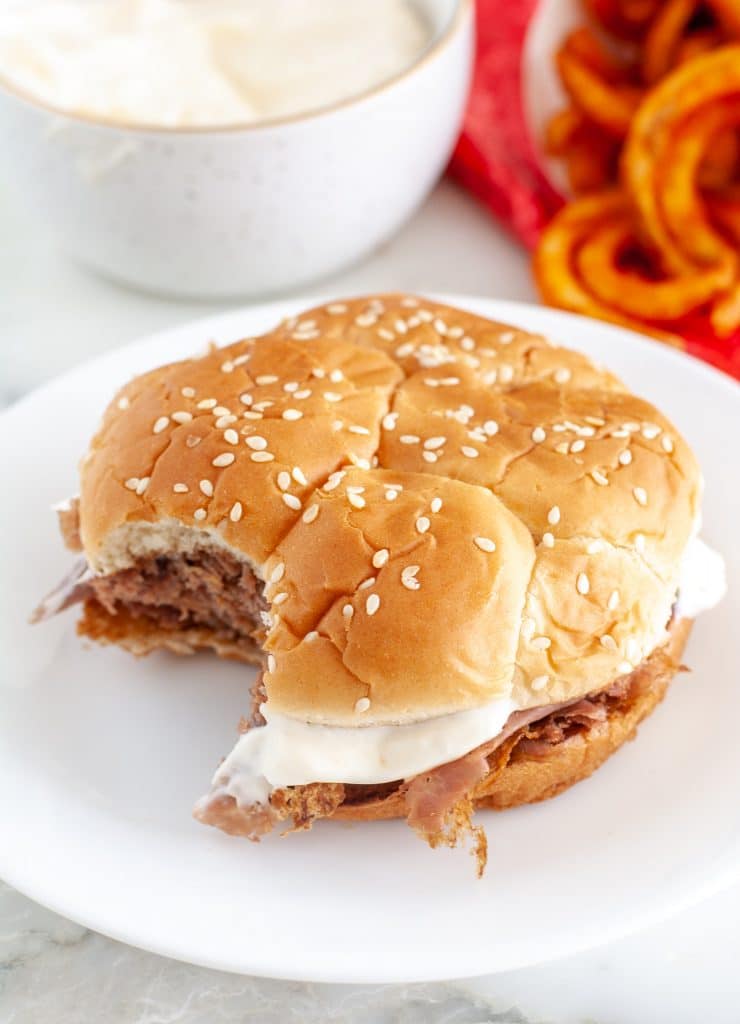 Roast beef sandwich on plate.