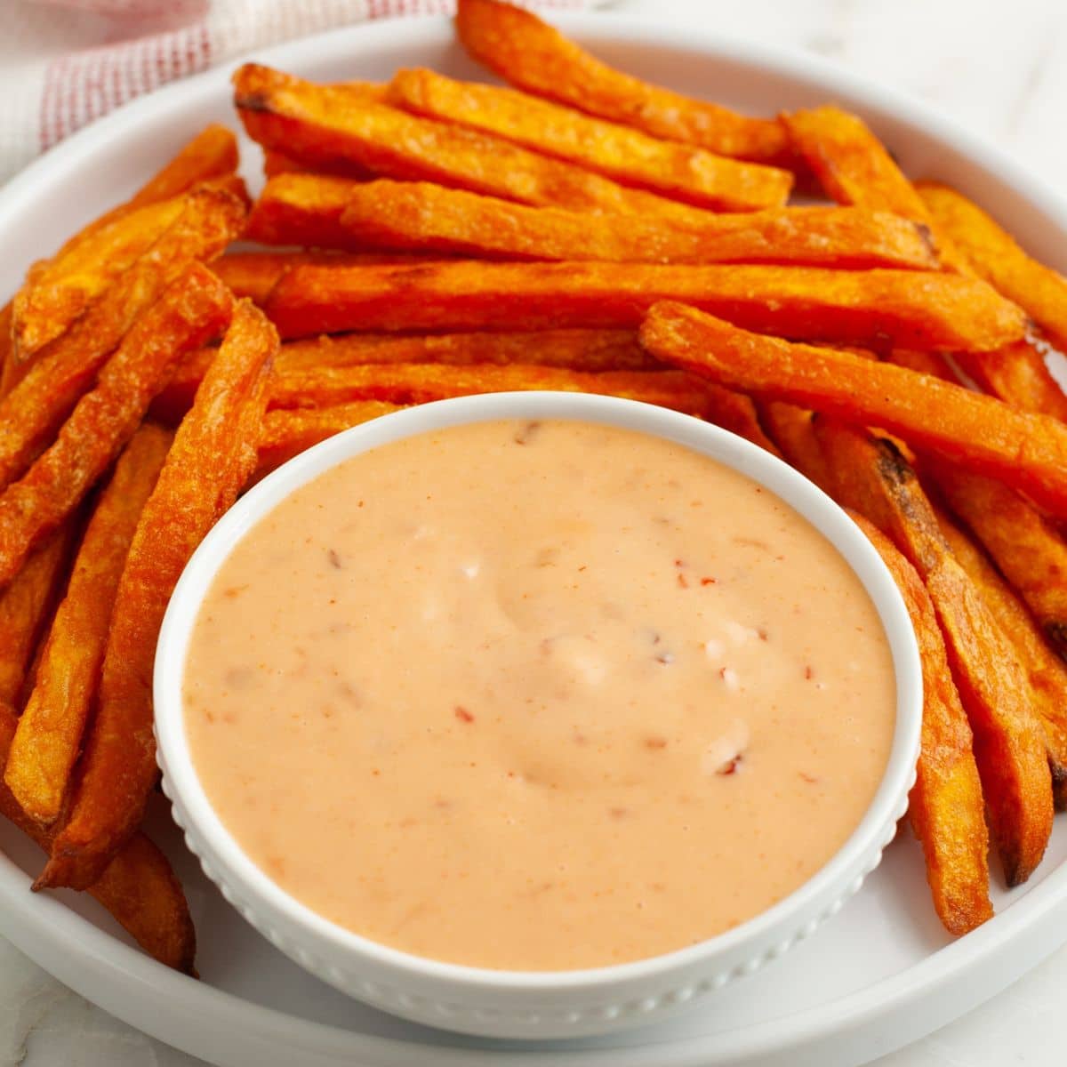 Bowl of boom boom sauce with sweet potato fries. 