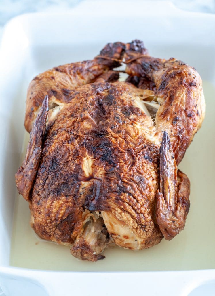 Whole chicken in baking dish.