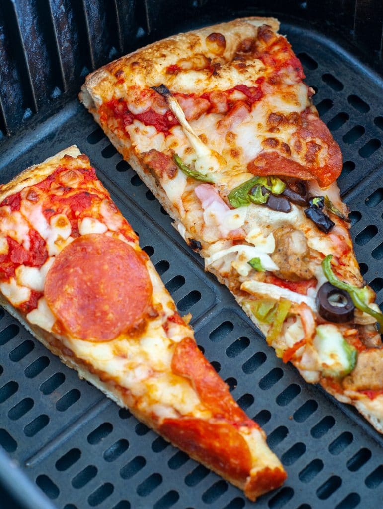 Pizza slices in air fryer basket. 