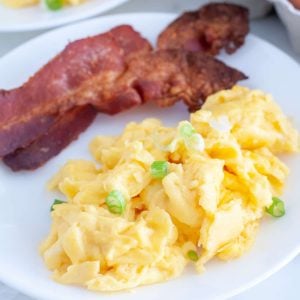 Plate with scrambled eggs and bacon.