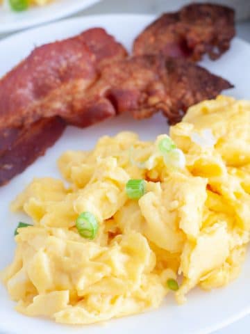 Plate with scrambled eggs and bacon.
