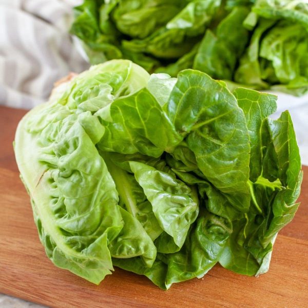 Head of lettuce on cutting board.