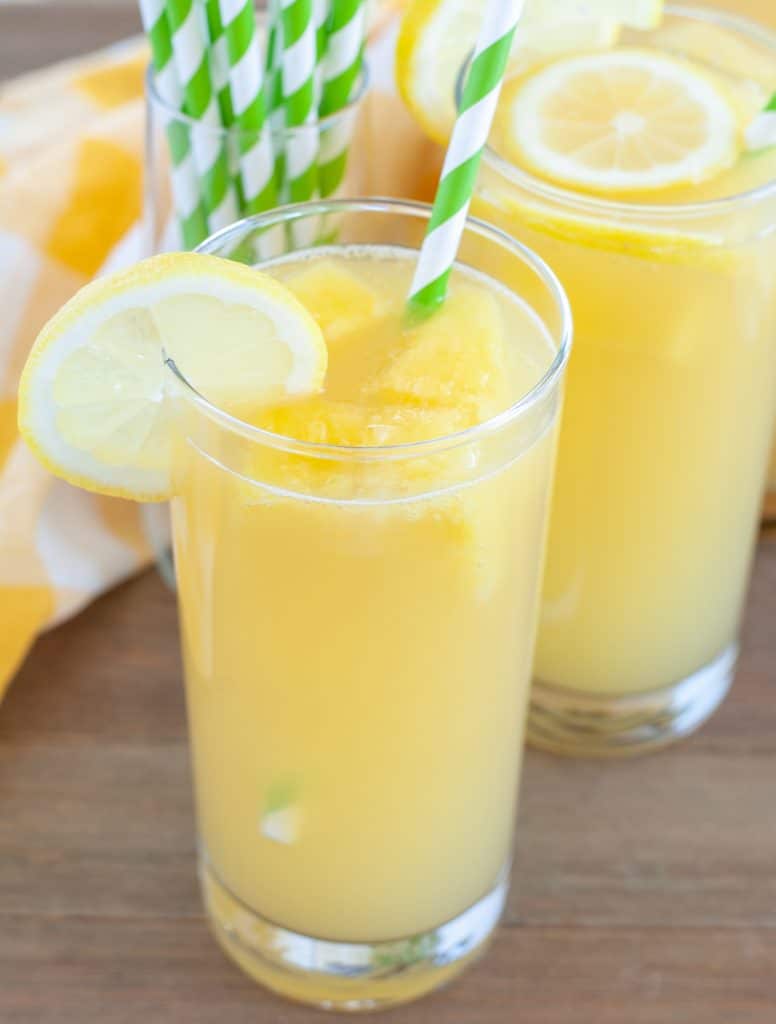 Glasses of lemonade with green straw. 