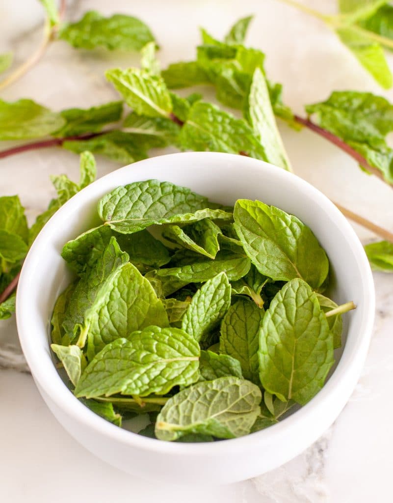 A bowl of mint leaves. 