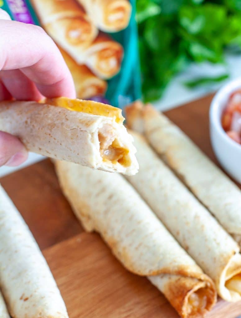 Hand holding taquito.