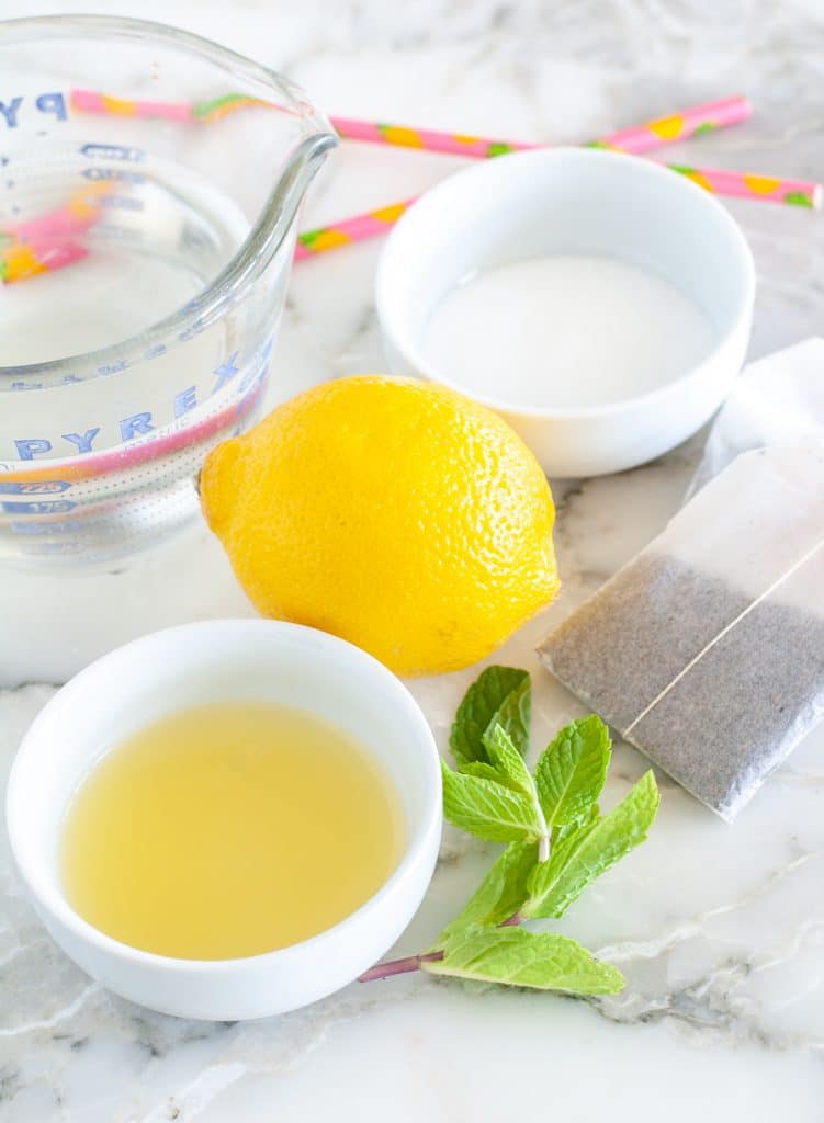 Bowl of pineapple juice, lemon, mint leaves and sugar. 