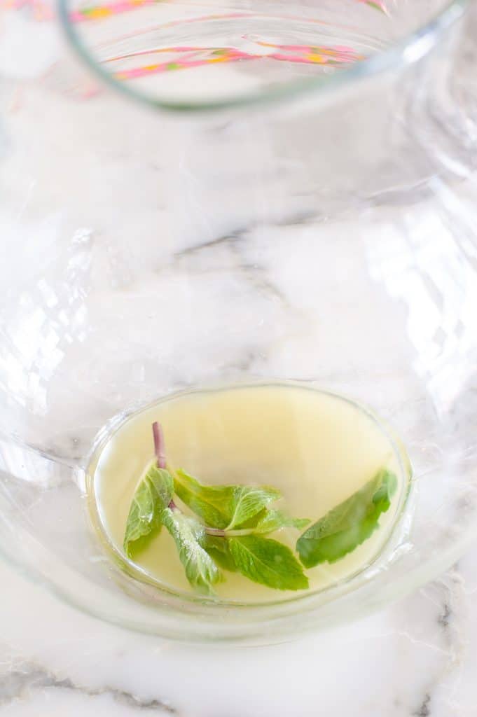 Pitcher with juice, sugar and mint leaves. 