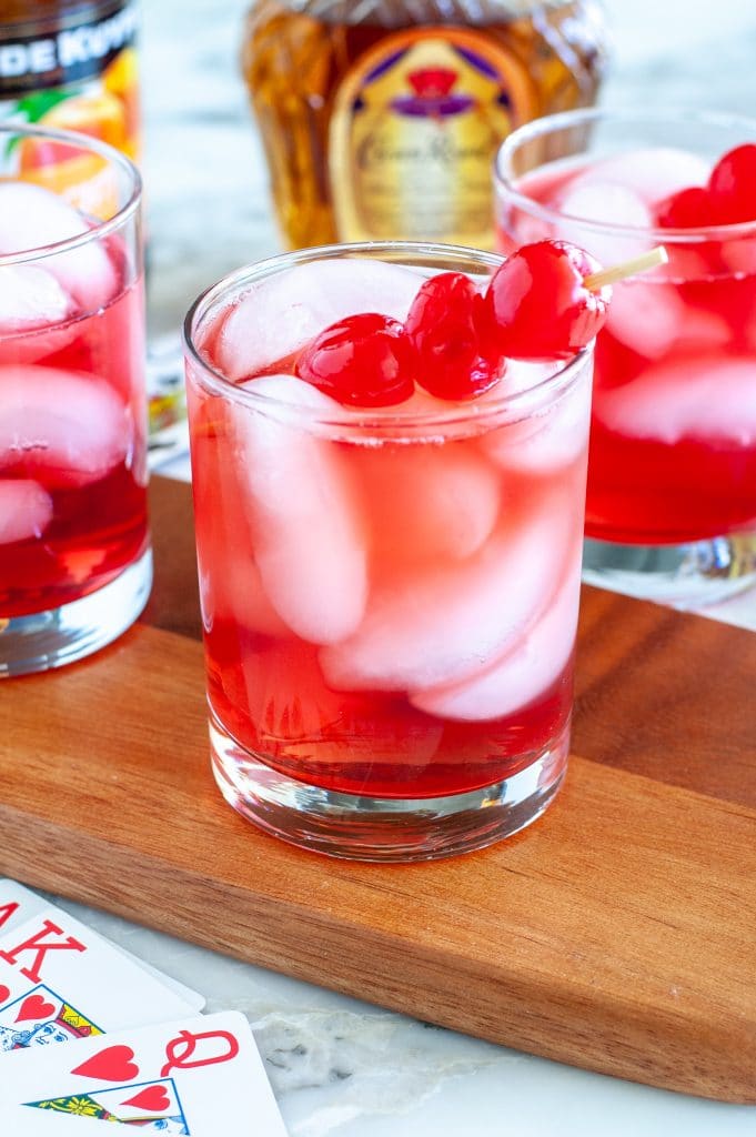 Glass with red drink and cherries. 