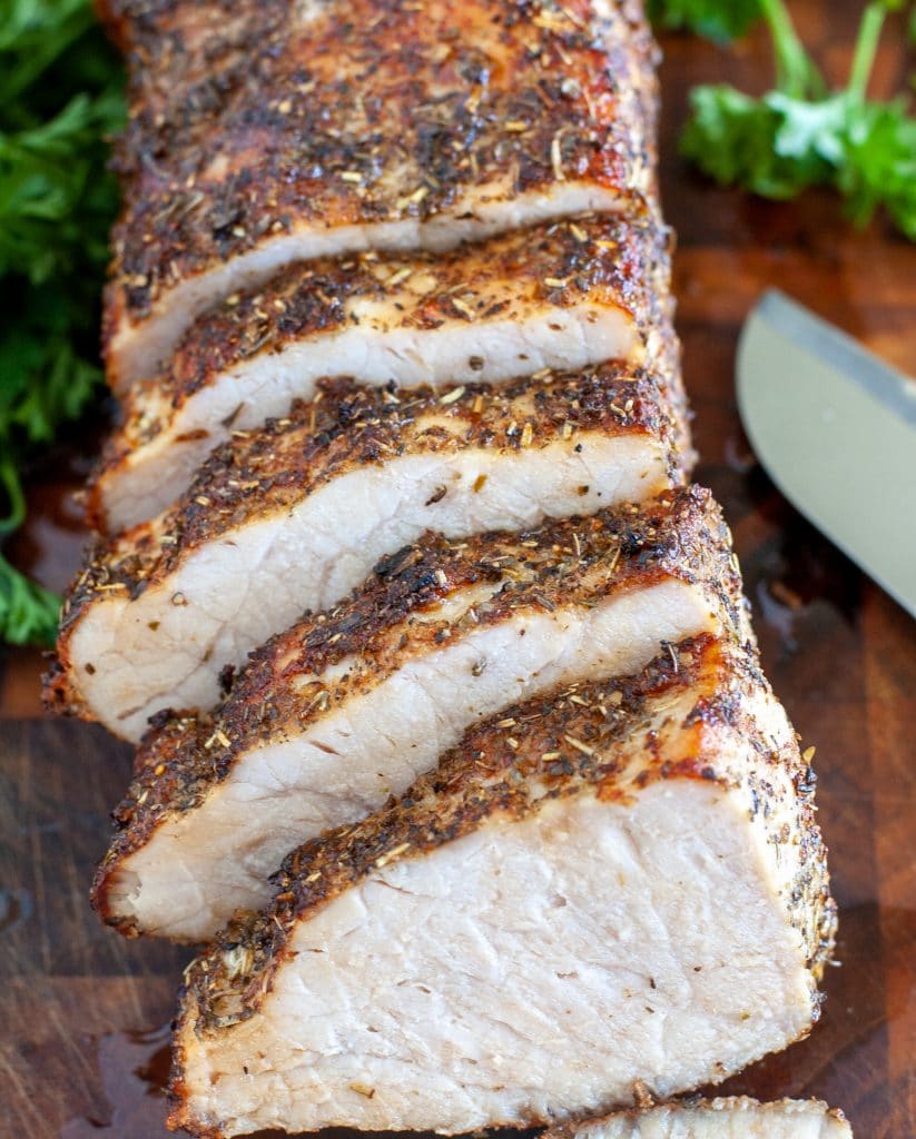 Sliced pork loin on cutting board. 