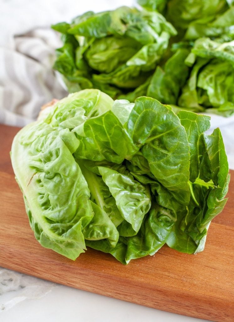 Head of lettuce on cutting board. 