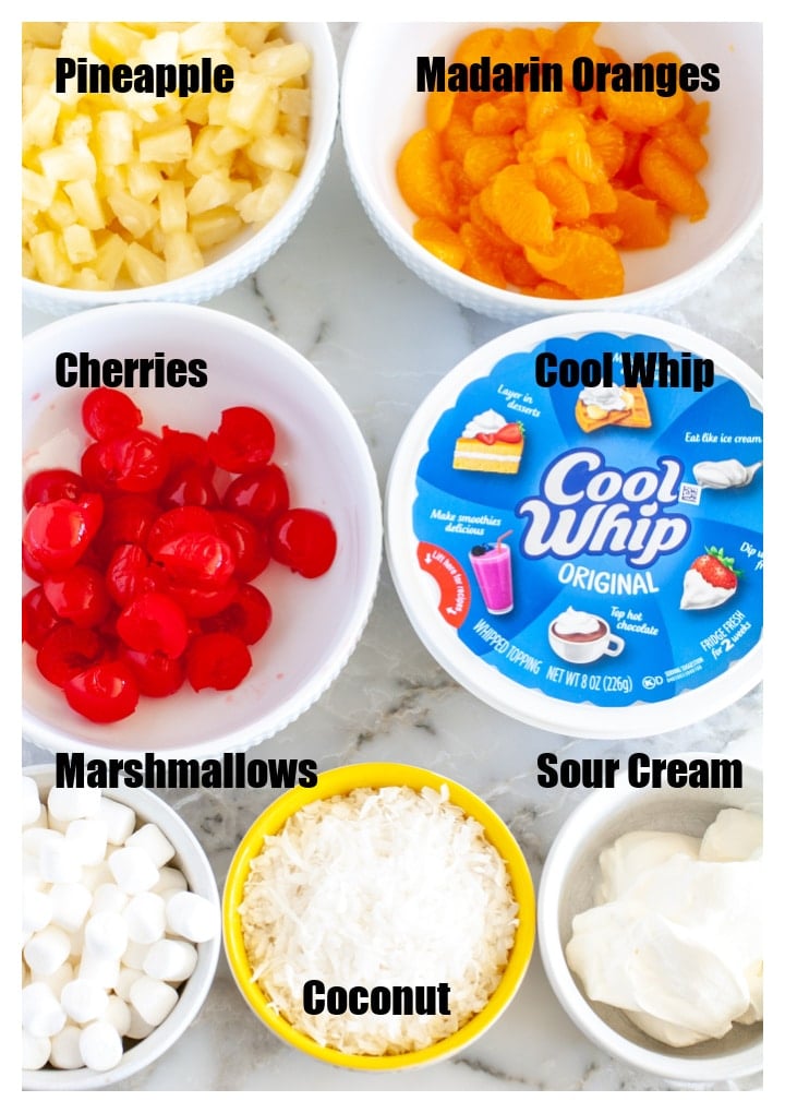 Bowls of cherries, pineapple, oranges, marshmallows, coconut, sour cream and Cool Whip. 