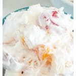 Blue bowl with creamy fruit salad.