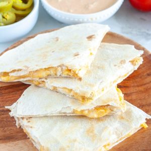 Plate of quesadillas cut into triangles.