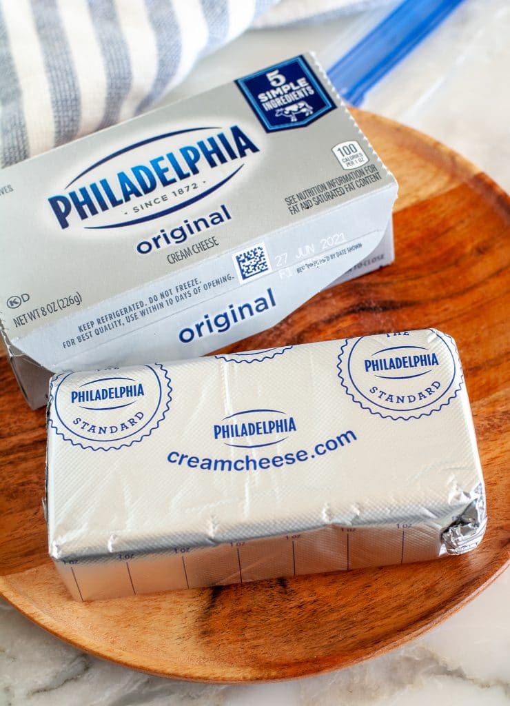 Block of cream cheese on a plate.
