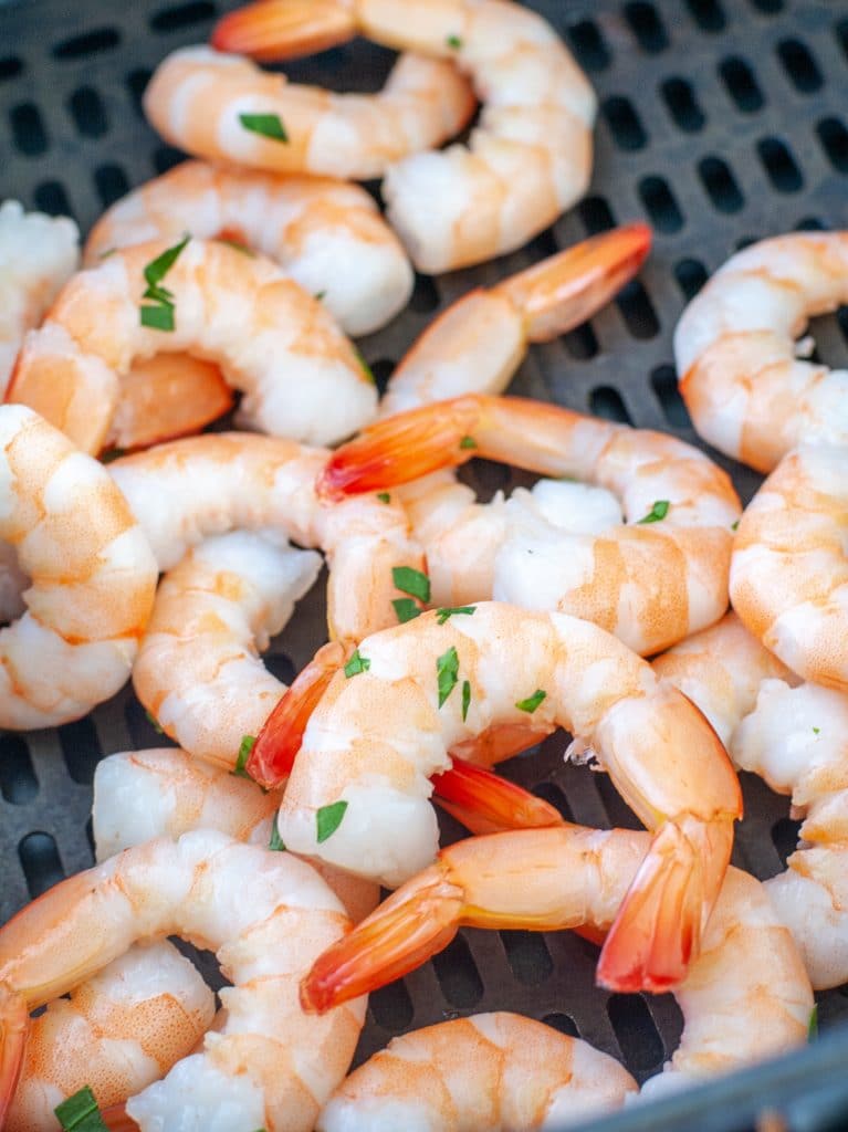 Shrimp in air fryer basket. 