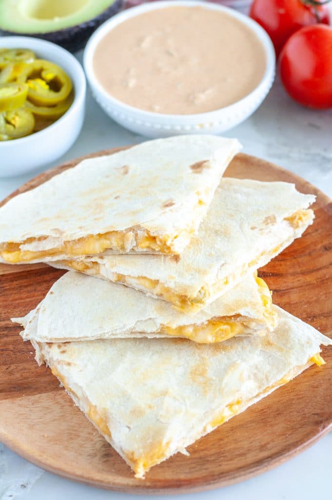 Plate of quesadillas and bowl of sauce. 