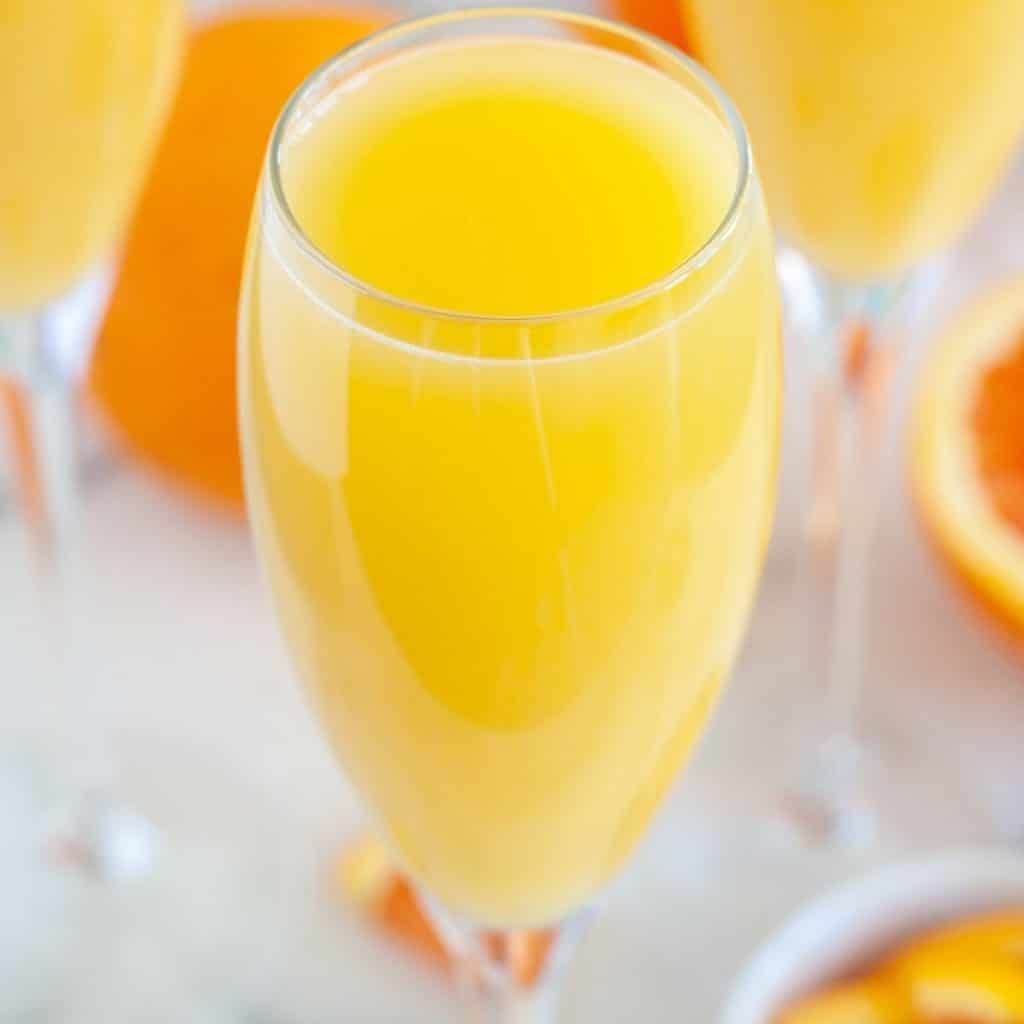 Glass filled with orange juice.