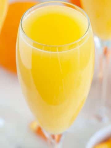 Glass filled with orange juice.