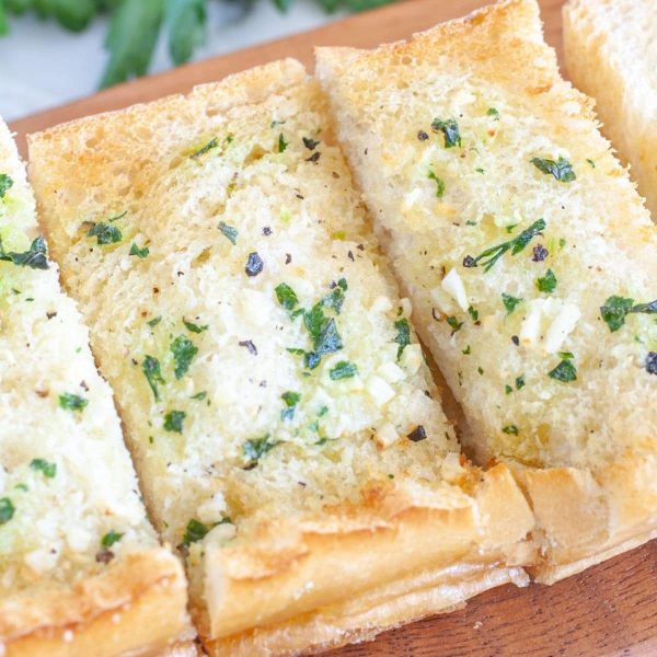 Bread with garlic on cutting board.