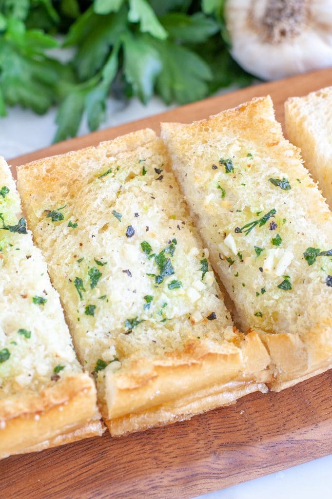 Toasted bread on cutting board. 