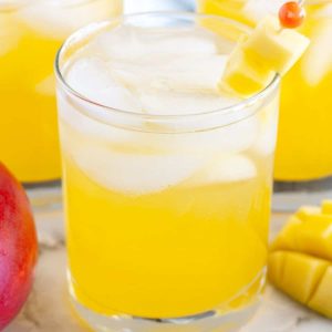 Glasses of juice with diced mango.