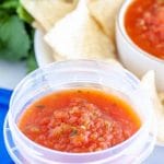 Container filled with salsa.