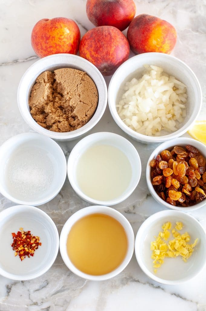 Bowls vinegar, spices, sugar and peaches.