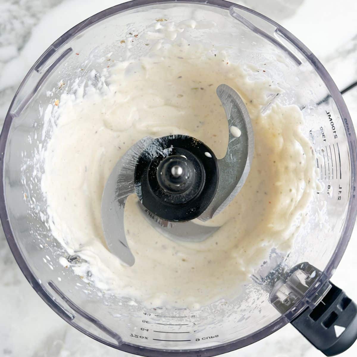Food processor with white sauce.