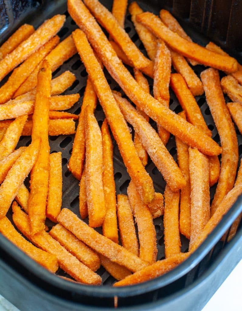 Frozen fries in air fryer basket. 