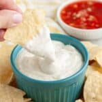 Bowl of white sauce, bowl of salsa, and tortilla chips.