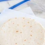 Tortillas stacked on parchment.