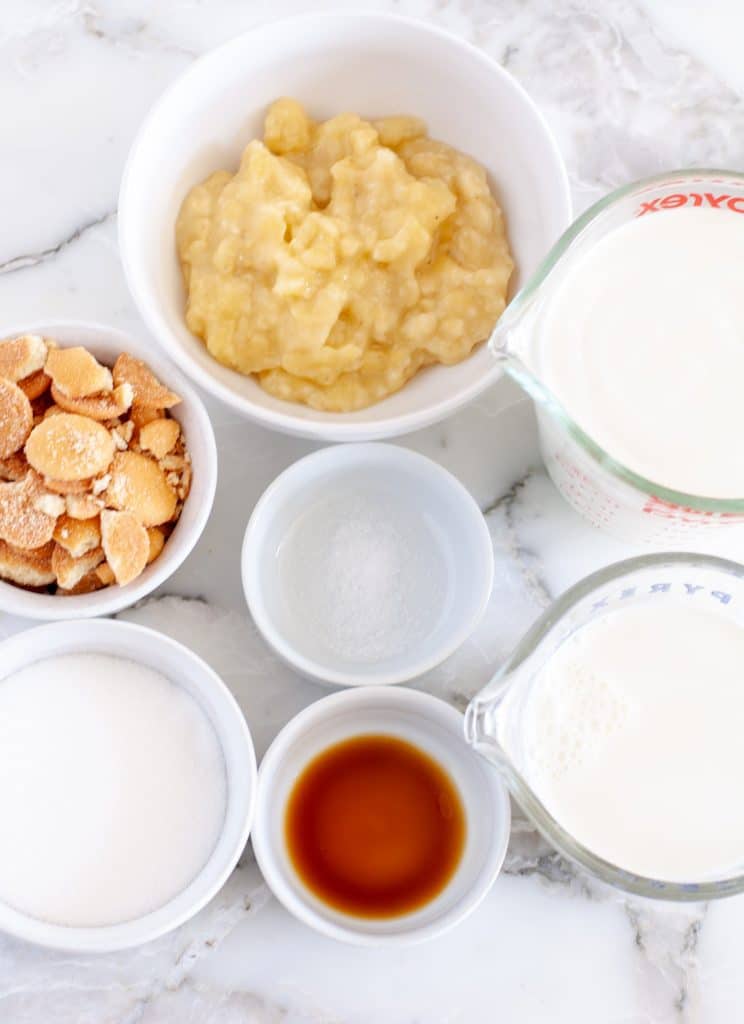 Bowl of mashed banana, sugar, vanilla, cream. 