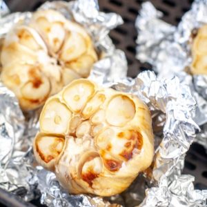 Head of roasted garlic wrapped in foil.
