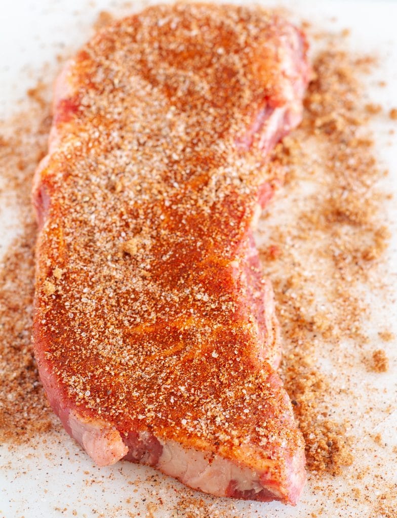 Raw steak with seasonings.