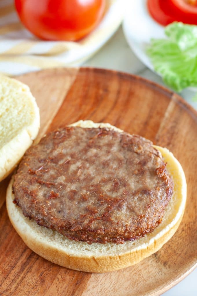 Hamburger bun on a plate with a turkey burger patty.