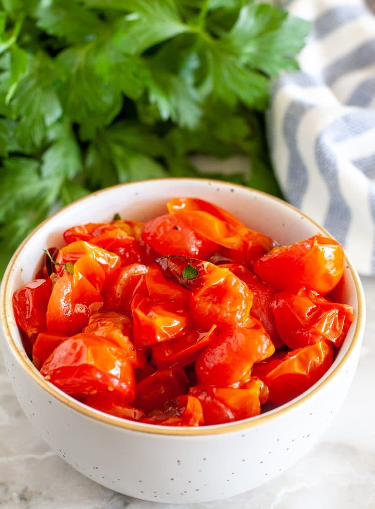 Roasted tomatoes in a white bowl. 