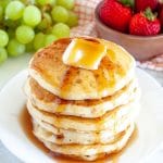 Stack of pancakes with butter and syrup.
