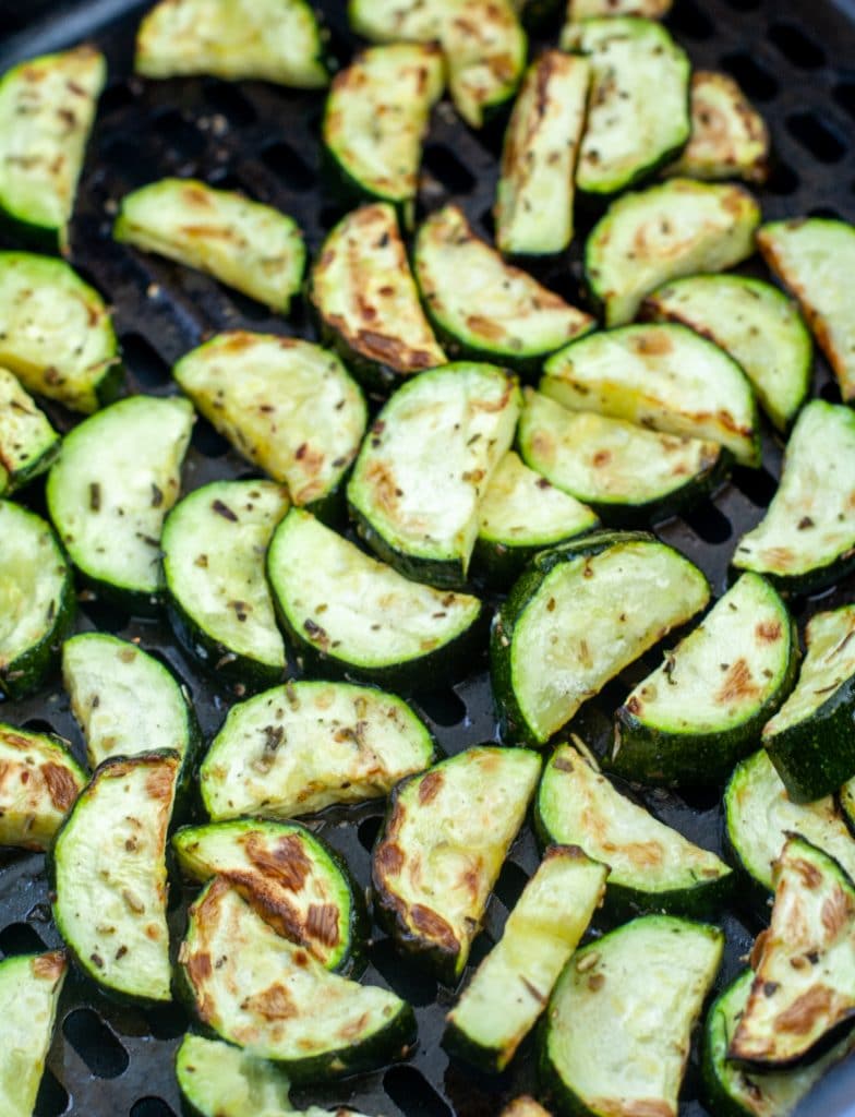 Roasted zucchini in air fryer basket. 