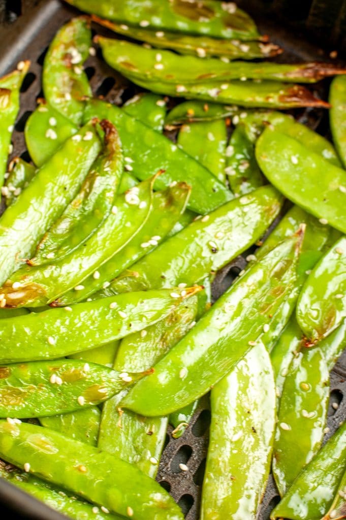 Cooked peas in air fryer basket. 