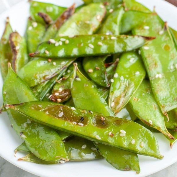 Plate of snow peas and sesame seeds.