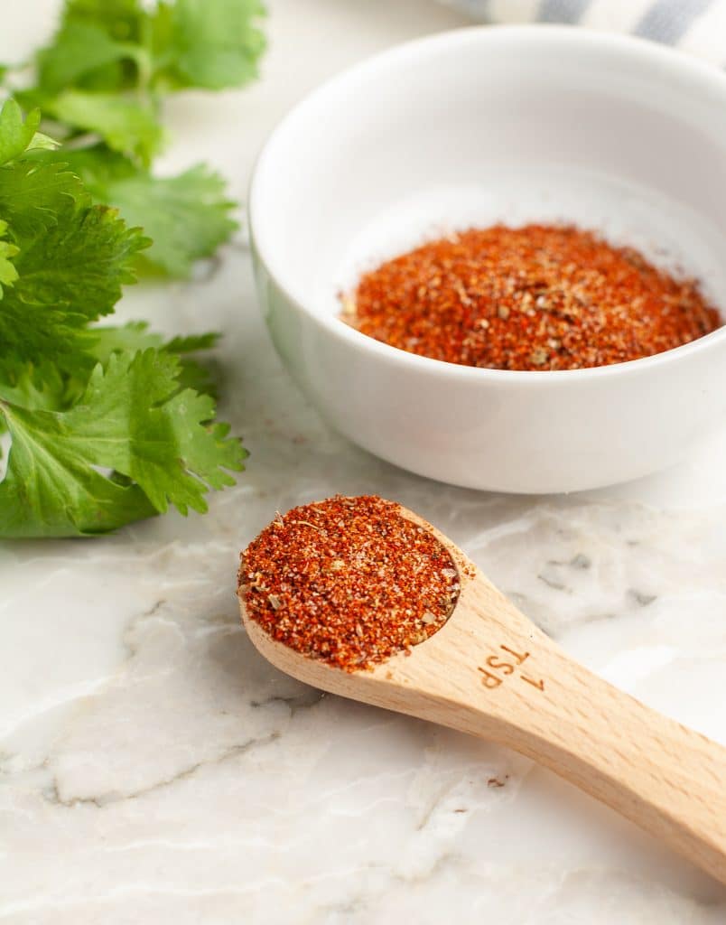 Wooden spoon filled with spices. 