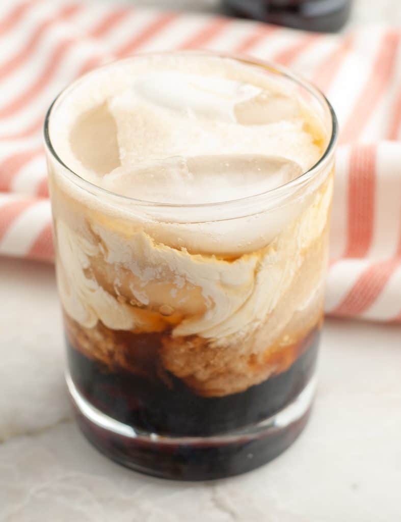 Glass filled with cream and cola.