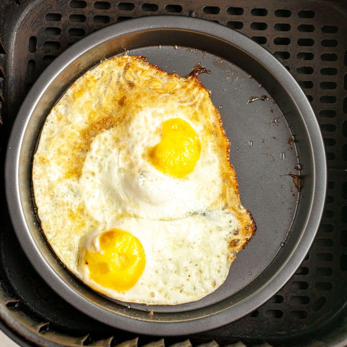 Pan with fried eggs in the pan.