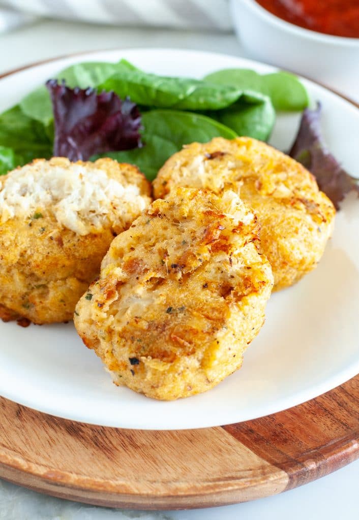 Plate with three crab cakes. 