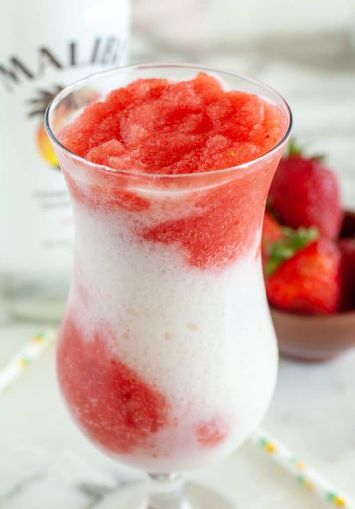 Glass filled with red and white drink. 