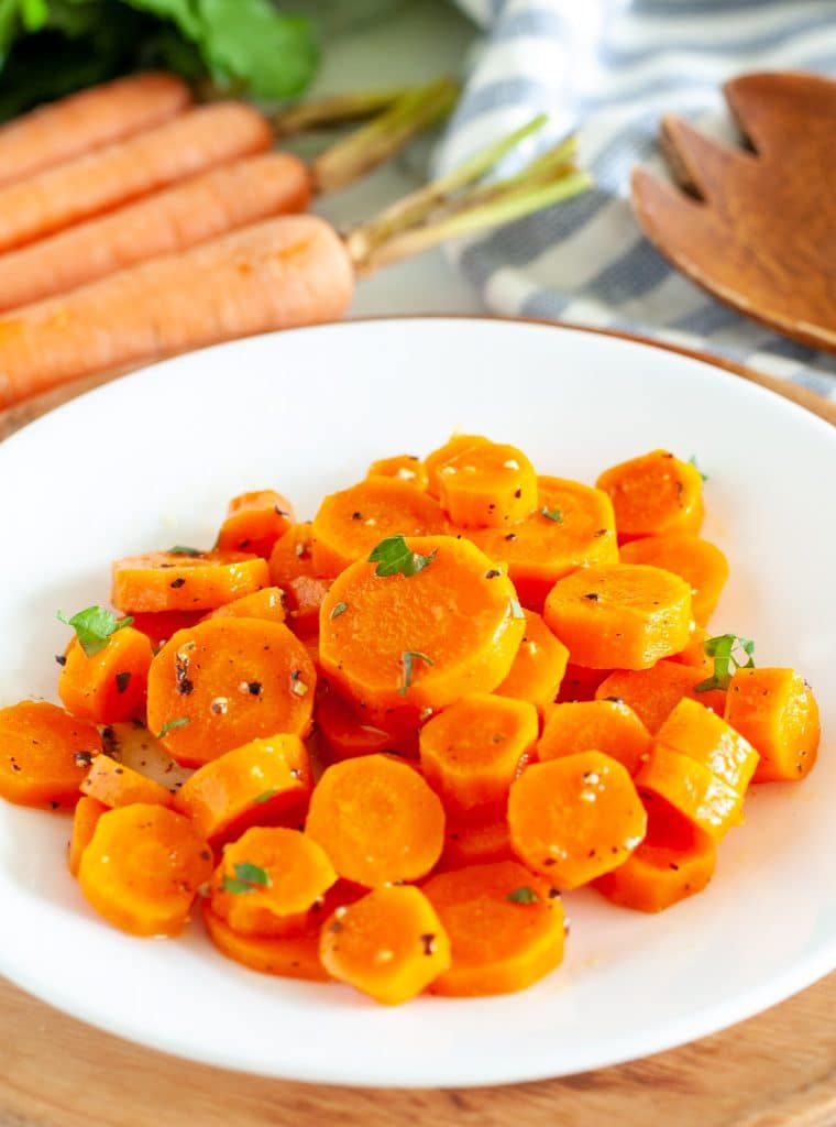 Cooked sliced carrots on a plate. 