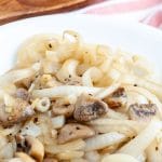Bowl of cooked onions and mushrooms.